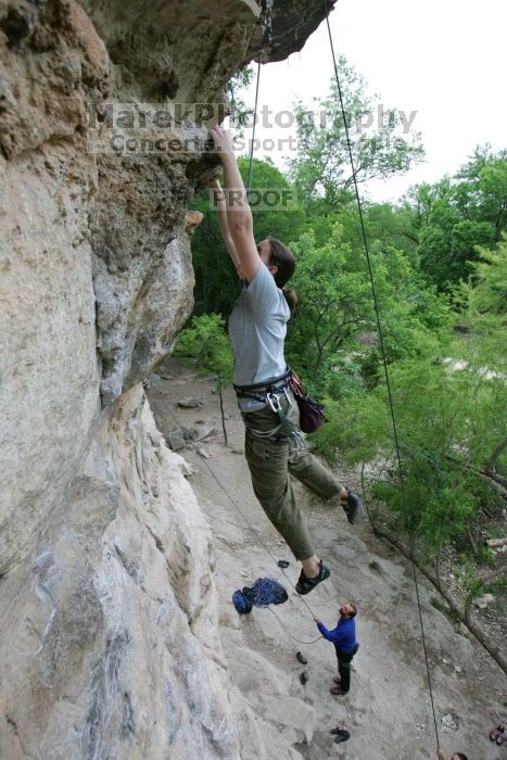 Hannah Norton top rope climbing Diving for Rocks (5.10d), photographed from  the third bolt of Magster (5.10a).  It was another long day of rock climbing at Seismic Wall on Austin's Barton Creek Greenbelt, Saturday, April 11, 2009.

Filename: SRM_20090411_16134171.JPG
Aperture: f/4.0
Shutter Speed: 1/250
Body: Canon EOS-1D Mark II
Lens: Canon EF 16-35mm f/2.8 L