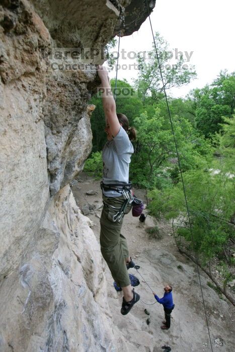 Hannah Norton top rope climbing Diving for Rocks (5.10d), photographed from  the third bolt of Magster (5.10a).  It was another long day of rock climbing at Seismic Wall on Austin's Barton Creek Greenbelt, Saturday, April 11, 2009.

Filename: SRM_20090411_16134376.JPG
Aperture: f/4.0
Shutter Speed: 1/250
Body: Canon EOS-1D Mark II
Lens: Canon EF 16-35mm f/2.8 L