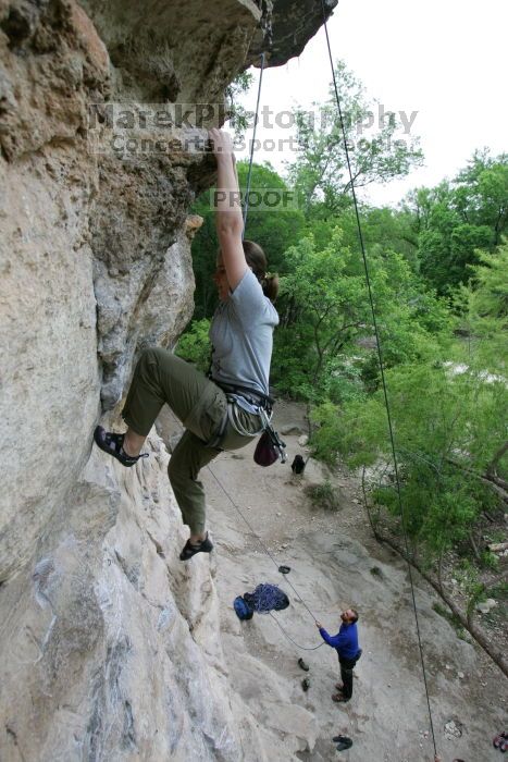 Hannah Norton top rope climbing Diving for Rocks (5.10d), photographed from  the third bolt of Magster (5.10a).  It was another long day of rock climbing at Seismic Wall on Austin's Barton Creek Greenbelt, Saturday, April 11, 2009.

Filename: SRM_20090411_16134477.JPG
Aperture: f/4.0
Shutter Speed: 1/250
Body: Canon EOS-1D Mark II
Lens: Canon EF 16-35mm f/2.8 L