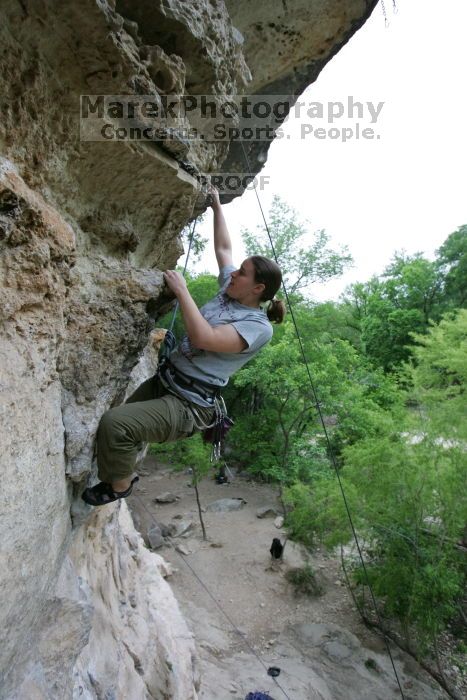 Hannah Norton top rope climbing Diving for Rocks (5.10d), photographed from  the third bolt of Magster (5.10a).  It was another long day of rock climbing at Seismic Wall on Austin's Barton Creek Greenbelt, Saturday, April 11, 2009.

Filename: SRM_20090411_16135579.JPG
Aperture: f/4.0
Shutter Speed: 1/250
Body: Canon EOS-1D Mark II
Lens: Canon EF 16-35mm f/2.8 L