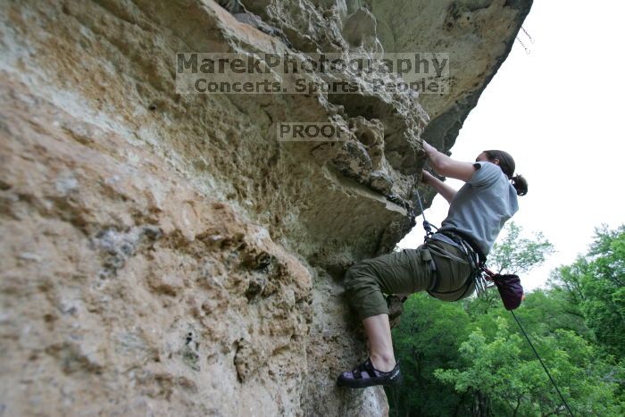 Hannah Norton top rope climbing Diving for Rocks (5.10d), photographed from  the third bolt of Magster (5.10a).  It was another long day of rock climbing at Seismic Wall on Austin's Barton Creek Greenbelt, Saturday, April 11, 2009.

Filename: SRM_20090411_16142585.JPG
Aperture: f/4.0
Shutter Speed: 1/250
Body: Canon EOS-1D Mark II
Lens: Canon EF 16-35mm f/2.8 L