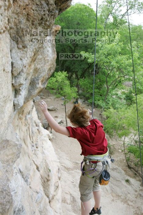 Kirsten Viering top rope climbing Diving for Rocks (5.10d), photographed from  the third bolt of Magster (5.10a).  It was another long day of rock climbing at Seismic Wall on Austin's Barton Creek Greenbelt, Saturday, April 11, 2009.

Filename: SRM_20090411_16374466.JPG
Aperture: f/5.6
Shutter Speed: 1/320
Body: Canon EOS-1D Mark II
Lens: Canon EF 16-35mm f/2.8 L