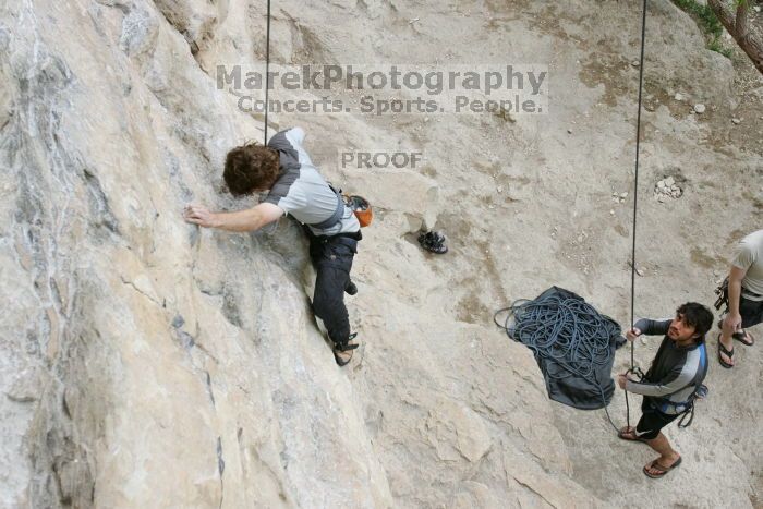 Andrew Dreher top rope climbing Diving for Rocks (5.10d) with Javier Morales belaying, photographed from  the third bolt of Magster (5.10a).  It was another long day of rock climbing at Seismic Wall on Austin's Barton Creek Greenbelt, Saturday, April 11, 2009.

Filename: SRM_20090411_16410668.JPG
Aperture: f/5.6
Shutter Speed: 1/320
Body: Canon EOS-1D Mark II
Lens: Canon EF 16-35mm f/2.8 L