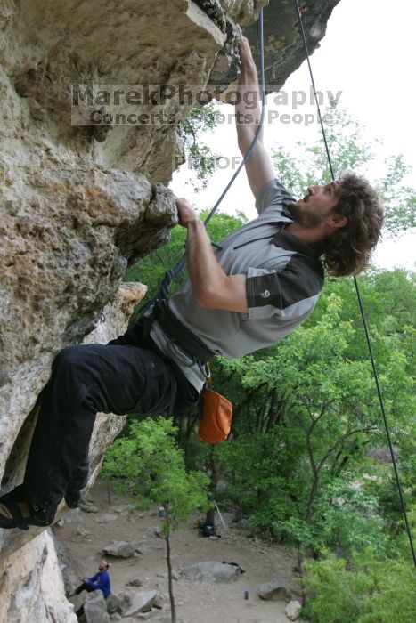 Andrew Dreher top rope climbing Diving for Rocks (5.10d), photographed from  the third bolt of Magster (5.10a).  It was another long day of rock climbing at Seismic Wall on Austin's Barton Creek Greenbelt, Saturday, April 11, 2009.

Filename: SRM_20090411_16425306.JPG
Aperture: f/5.6
Shutter Speed: 1/320
Body: Canon EOS-1D Mark II
Lens: Canon EF 16-35mm f/2.8 L