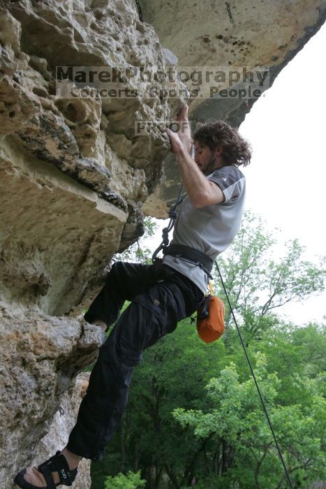 Andrew Dreher top rope climbing Diving for Rocks (5.10d), photographed from  the third bolt of Magster (5.10a).  It was another long day of rock climbing at Seismic Wall on Austin's Barton Creek Greenbelt, Saturday, April 11, 2009.

Filename: SRM_20090411_16430109.JPG
Aperture: f/5.6
Shutter Speed: 1/320
Body: Canon EOS-1D Mark II
Lens: Canon EF 16-35mm f/2.8 L