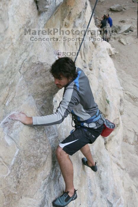 Javier Morales top rope climbing Diving for Rocks (5.10d), photographed from  the third bolt of Magster (5.10a).  It was another long day of rock climbing at Seismic Wall on Austin's Barton Creek Greenbelt, Saturday, April 11, 2009.

Filename: SRM_20090411_16481314.JPG
Aperture: f/5.6
Shutter Speed: 1/320
Body: Canon EOS-1D Mark II
Lens: Canon EF 16-35mm f/2.8 L