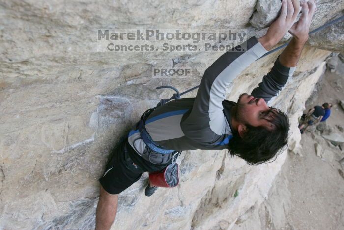 Javier Morales top rope climbing Diving for Rocks (5.10d), photographed from  the third bolt of Magster (5.10a).  It was another long day of rock climbing at Seismic Wall on Austin's Barton Creek Greenbelt, Saturday, April 11, 2009.

Filename: SRM_20090411_16483224.JPG
Aperture: f/5.6
Shutter Speed: 1/320
Body: Canon EOS-1D Mark II
Lens: Canon EF 16-35mm f/2.8 L