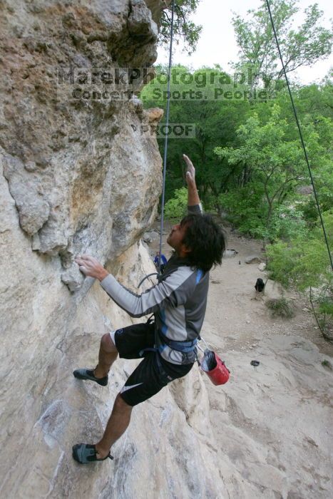 Javier Morales top rope climbing Diving for Rocks (5.10d), photographed from  the third bolt of Magster (5.10a).  It was another long day of rock climbing at Seismic Wall on Austin's Barton Creek Greenbelt, Saturday, April 11, 2009.

Filename: SRM_20090411_16485444.JPG
Aperture: f/5.6
Shutter Speed: 1/320
Body: Canon EOS-1D Mark II
Lens: Canon EF 16-35mm f/2.8 L