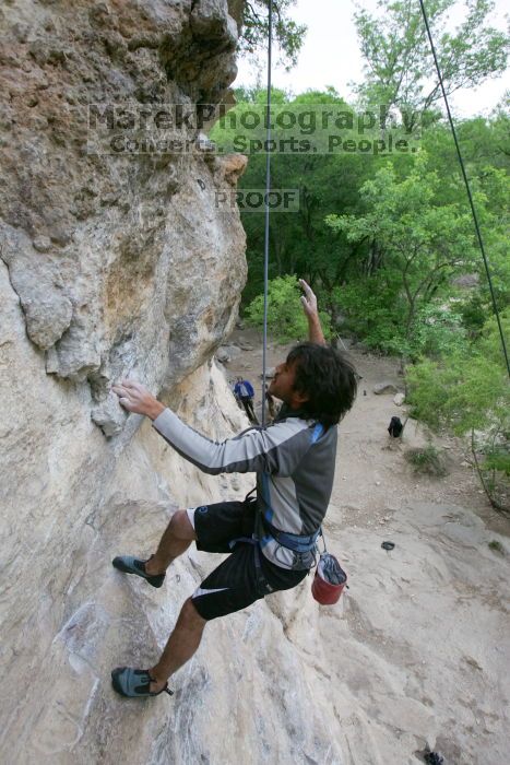 Javier Morales top rope climbing Diving for Rocks (5.10d), photographed from  the third bolt of Magster (5.10a).  It was another long day of rock climbing at Seismic Wall on Austin's Barton Creek Greenbelt, Saturday, April 11, 2009.

Filename: SRM_20090411_16485445.JPG
Aperture: f/5.6
Shutter Speed: 1/320
Body: Canon EOS-1D Mark II
Lens: Canon EF 16-35mm f/2.8 L