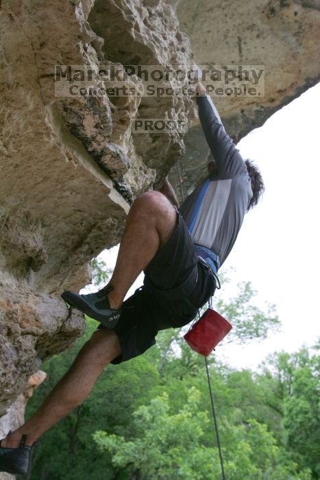 Javier Morales top rope climbing Diving for Rocks (5.10d), photographed from  the third bolt of Magster (5.10a).  It was another long day of rock climbing at Seismic Wall on Austin's Barton Creek Greenbelt, Saturday, April 11, 2009.

Filename: SRM_20090411_16493668.JPG
Aperture: f/5.6
Shutter Speed: 1/320
Body: Canon EOS-1D Mark II
Lens: Canon EF 16-35mm f/2.8 L