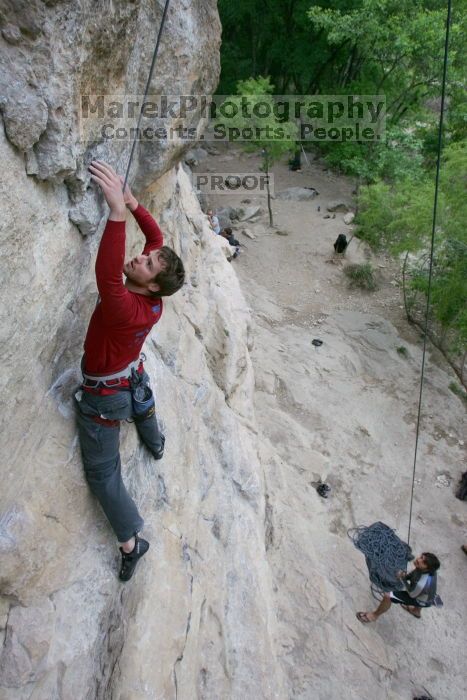 Me top rope climbing Diving for Rocks (5.10d) with Javier Morales belaying, photographed from  the third bolt of Magster (5.10a) by Andrew Dreher.  It was another long day of rock climbing at Seismic Wall on Austin's Barton Creek Greenbelt, Saturday, April 11, 2009.

Filename: SRM_20090411_17075420.JPG
Aperture: f/5.6
Shutter Speed: 1/320
Body: Canon EOS-1D Mark II
Lens: Canon EF 16-35mm f/2.8 L