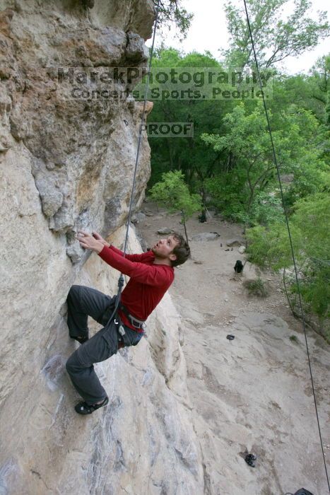 Me top rope climbing Diving for Rocks (5.10d), photographed from  the third bolt of Magster (5.10a) by Andrew Dreher.  It was another long day of rock climbing at Seismic Wall on Austin's Barton Creek Greenbelt, Saturday, April 11, 2009.

Filename: SRM_20090411_17080927.JPG
Aperture: f/5.6
Shutter Speed: 1/320
Body: Canon EOS-1D Mark II
Lens: Canon EF 16-35mm f/2.8 L