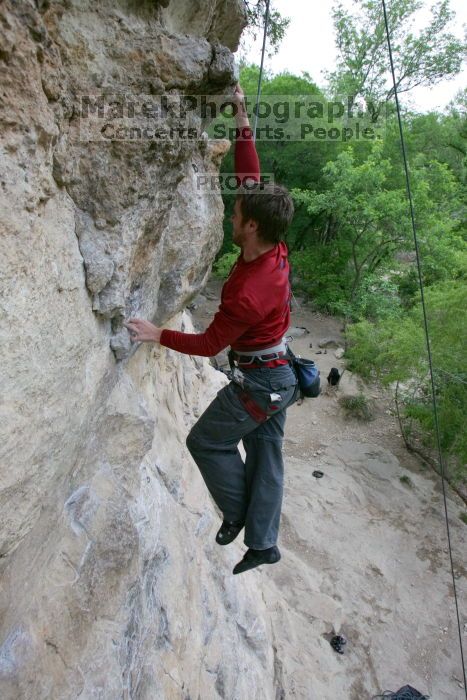 Me top rope climbing Diving for Rocks (5.10d), photographed from  the third bolt of Magster (5.10a) by Andrew Dreher.  It was another long day of rock climbing at Seismic Wall on Austin's Barton Creek Greenbelt, Saturday, April 11, 2009.

Filename: SRM_20090411_17103767.JPG
Aperture: f/5.6
Shutter Speed: 1/320
Body: Canon EOS-1D Mark II
Lens: Canon EF 16-35mm f/2.8 L