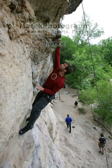 Me top rope climbing Diving for Rocks (5.10d), photographed from  the third bolt of Magster (5.10a) by Andrew Dreher.  It was another long day of rock climbing at Seismic Wall on Austin's Barton Creek Greenbelt, Saturday, April 11, 2009.

Filename: SRM_20090411_17165041.JPG
Aperture: f/5.6
Shutter Speed: 1/320
Body: Canon EOS-1D Mark II
Lens: Canon EF 16-35mm f/2.8 L