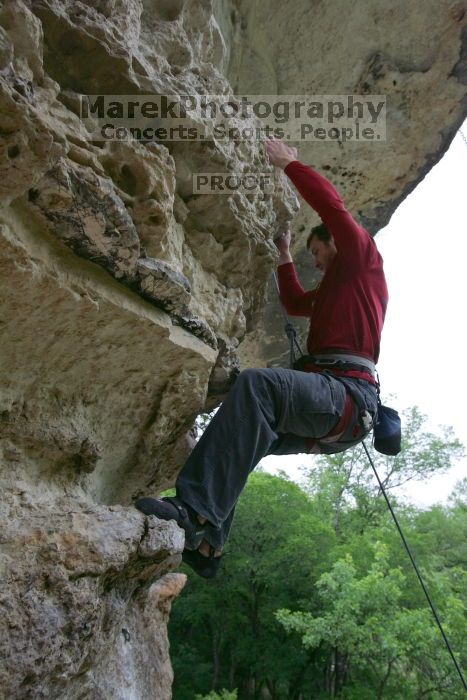 Me top rope climbing Diving for Rocks (5.10d), photographed from  the third bolt of Magster (5.10a) by Andrew Dreher.  It was another long day of rock climbing at Seismic Wall on Austin's Barton Creek Greenbelt, Saturday, April 11, 2009.

Filename: SRM_20090411_17190783.JPG
Aperture: f/5.6
Shutter Speed: 1/320
Body: Canon EOS-1D Mark II
Lens: Canon EF 16-35mm f/2.8 L