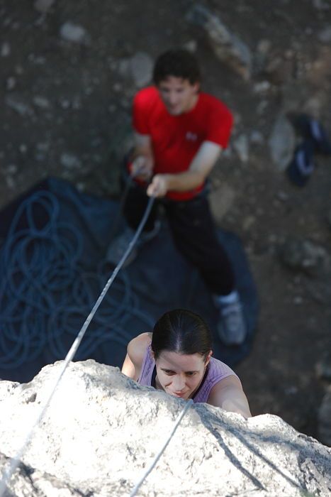 Beth Marek top rope climbing Roo Dog (5.8) with Andrew Dreher belaying, taken from the anchors of the route.  It was Beth's third time outside, and another long day of rock climbing at Seismic Wall on Austin's Barton Creek Greenbelt, Monday, May 25, 2009.

Filename: SRM_20090525_09405082.JPG
Aperture: f/4.0
Shutter Speed: 1/500
Body: Canon EOS-1D Mark II
Lens: Canon EF 80-200mm f/2.8 L