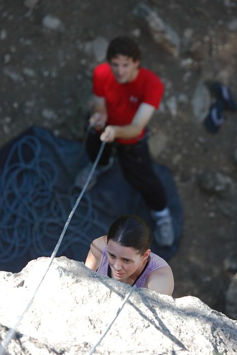 Beth Marek top rope climbing Roo Dog (5.8) with Andrew Dreher belaying, taken from the anchors of the route.  It was Beth's third time outside, and another long day of rock climbing at Seismic Wall on Austin's Barton Creek Greenbelt, Monday, May 25, 2009.

Filename: SRM_20090525_09405283.JPG
Aperture: f/4.0
Shutter Speed: 1/400
Body: Canon EOS-1D Mark II
Lens: Canon EF 80-200mm f/2.8 L