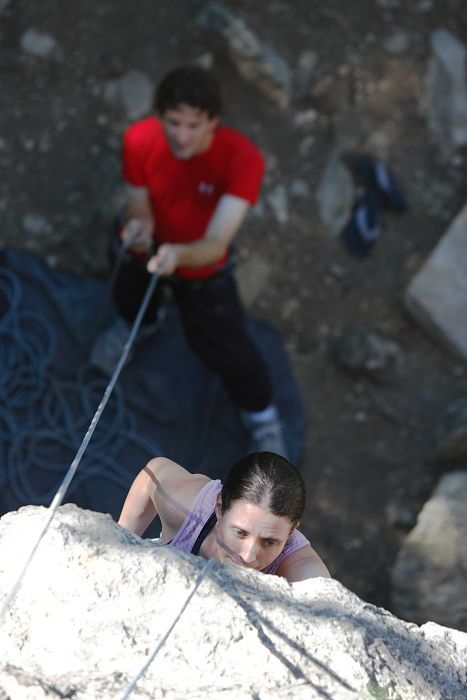 Beth Marek top rope climbing Roo Dog (5.8) with Andrew Dreher belaying, taken from the anchors of the route.  It was Beth's third time outside, and another long day of rock climbing at Seismic Wall on Austin's Barton Creek Greenbelt, Monday, May 25, 2009.

Filename: SRM_20090525_09405785.JPG
Aperture: f/4.0
Shutter Speed: 1/400
Body: Canon EOS-1D Mark II
Lens: Canon EF 80-200mm f/2.8 L