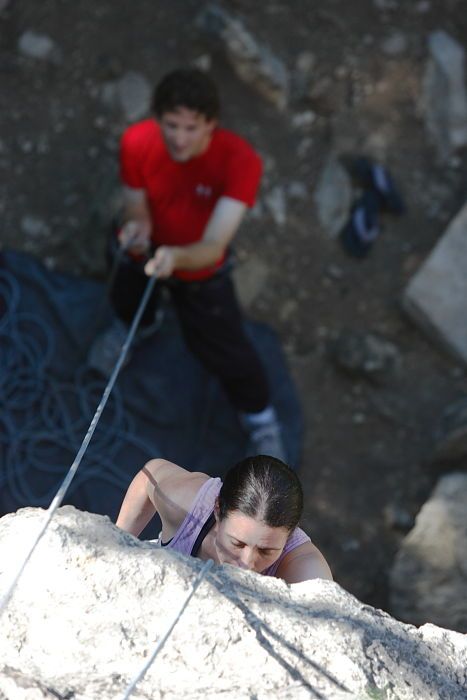 Beth Marek top rope climbing Roo Dog (5.8) with Andrew Dreher belaying, taken from the anchors of the route.  It was Beth's third time outside, and another long day of rock climbing at Seismic Wall on Austin's Barton Creek Greenbelt, Monday, May 25, 2009.

Filename: SRM_20090525_09405786.JPG
Aperture: f/4.0
Shutter Speed: 1/500
Body: Canon EOS-1D Mark II
Lens: Canon EF 80-200mm f/2.8 L