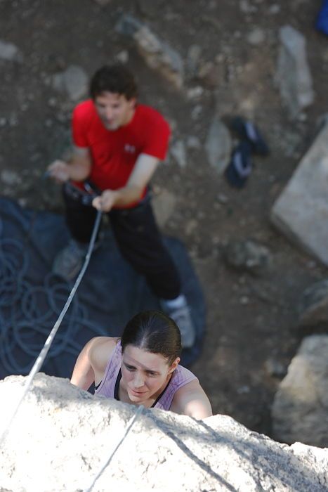 Beth Marek top rope climbing Roo Dog (5.8) with Andrew Dreher belaying, taken from the anchors of the route.  It was Beth's third time outside, and another long day of rock climbing at Seismic Wall on Austin's Barton Creek Greenbelt, Monday, May 25, 2009.

Filename: SRM_20090525_09410787.JPG
Aperture: f/4.0
Shutter Speed: 1/320
Body: Canon EOS-1D Mark II
Lens: Canon EF 80-200mm f/2.8 L