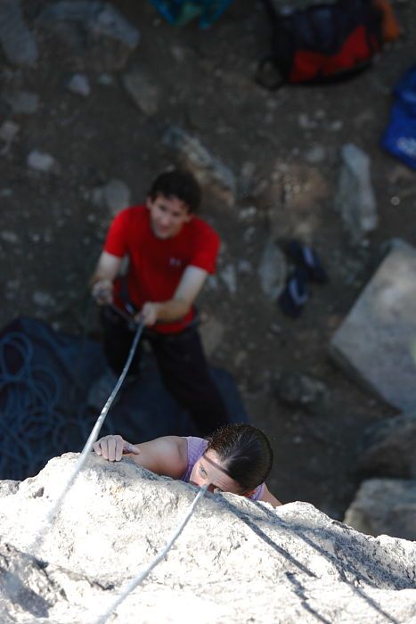 Beth Marek top rope climbing Roo Dog (5.8) with Andrew Dreher belaying, taken from the anchors of the route.  It was Beth's third time outside, and another long day of rock climbing at Seismic Wall on Austin's Barton Creek Greenbelt, Monday, May 25, 2009.

Filename: SRM_20090525_09414592.JPG
Aperture: f/4.0
Shutter Speed: 1/500
Body: Canon EOS-1D Mark II
Lens: Canon EF 80-200mm f/2.8 L