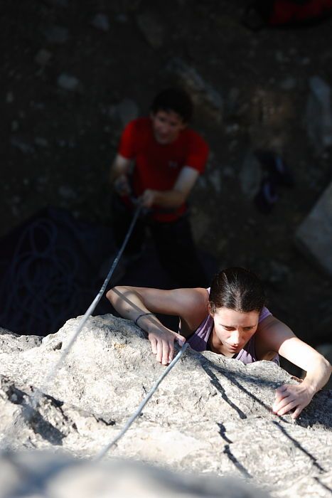 Beth Marek top rope climbing Roo Dog (5.8) with Andrew Dreher belaying, taken from the anchors of the route.  It was Beth's third time outside, and another long day of rock climbing at Seismic Wall on Austin's Barton Creek Greenbelt, Monday, May 25, 2009.

Filename: SRM_20090525_09415598.JPG
Aperture: f/4.0
Shutter Speed: 1/800
Body: Canon EOS-1D Mark II
Lens: Canon EF 80-200mm f/2.8 L