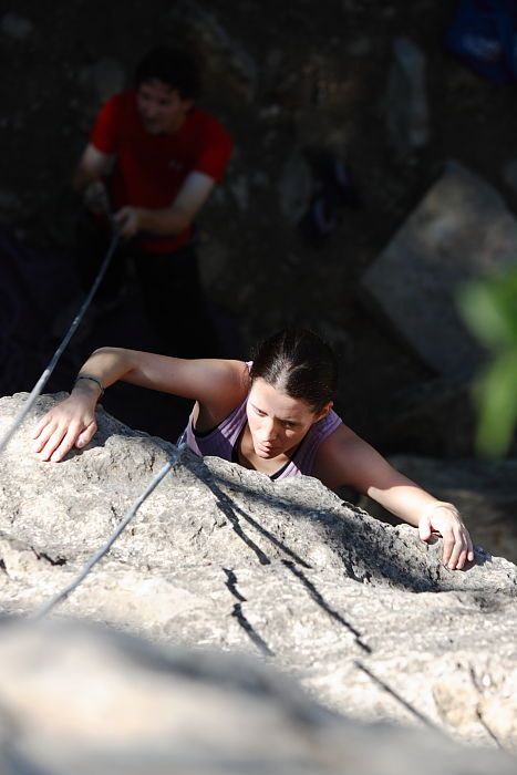 Beth Marek top rope climbing Roo Dog (5.8) with Andrew Dreher belaying, taken from the anchors of the route.  It was Beth's third time outside, and another long day of rock climbing at Seismic Wall on Austin's Barton Creek Greenbelt, Monday, May 25, 2009.

Filename: SRM_20090525_09420199.JPG
Aperture: f/4.0
Shutter Speed: 1/1000
Body: Canon EOS-1D Mark II
Lens: Canon EF 80-200mm f/2.8 L