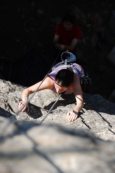 Beth Marek top rope climbing Roo Dog (5.8) with Andrew Dreher belaying, taken from the anchors of the route.  It was Beth's third time outside, and another long day of rock climbing at Seismic Wall on Austin's Barton Creek Greenbelt, Monday, May 25, 2009.

Filename: SRM_20090525_09423004.JPG
Aperture: f/4.0
Shutter Speed: 1/1600
Body: Canon EOS-1D Mark II
Lens: Canon EF 80-200mm f/2.8 L