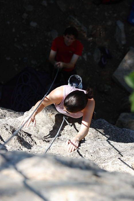 Beth Marek top rope climbing Roo Dog (5.8) with Andrew Dreher belaying, taken from the anchors of the route.  It was Beth's third time outside, and another long day of rock climbing at Seismic Wall on Austin's Barton Creek Greenbelt, Monday, May 25, 2009.

Filename: SRM_20090525_09424205.JPG
Aperture: f/5.6
Shutter Speed: 1/500
Body: Canon EOS-1D Mark II
Lens: Canon EF 80-200mm f/2.8 L