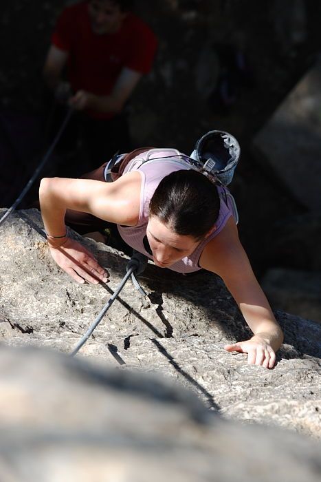 Beth Marek top rope climbing Roo Dog (5.8) with Andrew Dreher belaying, taken from the anchors of the route.  It was Beth's third time outside, and another long day of rock climbing at Seismic Wall on Austin's Barton Creek Greenbelt, Monday, May 25, 2009.

Filename: SRM_20090525_09430807.JPG
Aperture: f/5.6
Shutter Speed: 1/640
Body: Canon EOS-1D Mark II
Lens: Canon EF 80-200mm f/2.8 L