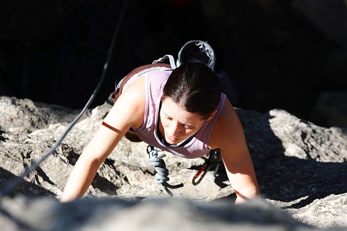 Beth Marek top rope climbing Roo Dog (5.8), taken from the anchors of the route.  It was Beth's third time outside, and another long day of rock climbing at Seismic Wall on Austin's Barton Creek Greenbelt, Monday, May 25, 2009.

Filename: SRM_20090525_09433811.JPG
Aperture: f/5.6
Shutter Speed: 1/1000
Body: Canon EOS-1D Mark II
Lens: Canon EF 80-200mm f/2.8 L