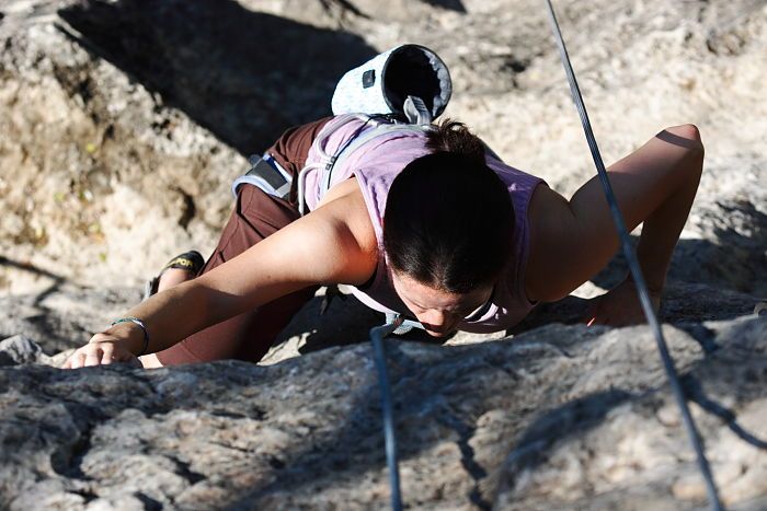 Beth Marek top rope climbing Roo Dog (5.8), taken from the anchors of the route.  It was Beth's third time outside, and another long day of rock climbing at Seismic Wall on Austin's Barton Creek Greenbelt, Monday, May 25, 2009.

Filename: SRM_20090525_09485937.JPG
Aperture: f/5.0
Shutter Speed: 1/1600
Body: Canon EOS-1D Mark II
Lens: Canon EF 80-200mm f/2.8 L