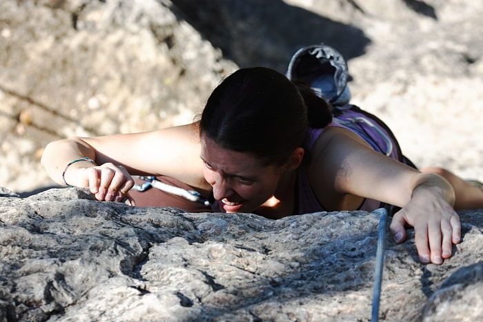 Beth Marek top rope climbing Roo Dog (5.8), taken from the anchors of the route.  It was Beth's third time outside, and another long day of rock climbing at Seismic Wall on Austin's Barton Creek Greenbelt, Monday, May 25, 2009.

Filename: SRM_20090525_09494446.JPG
Aperture: f/5.0
Shutter Speed: 1/1250
Body: Canon EOS-1D Mark II
Lens: Canon EF 80-200mm f/2.8 L