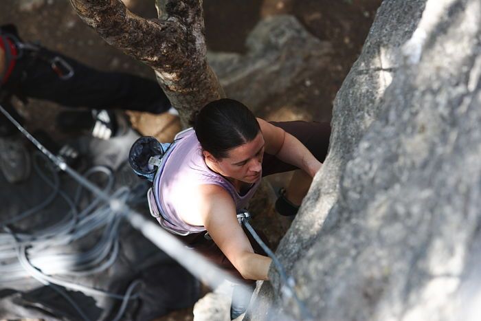 Beth Marek top rope climbing Hollywood (5.7), taken from the anchors of the route.  It was Beth's third time outside, and another long day of rock climbing at Seismic Wall on Austin's Barton Creek Greenbelt, Monday, May 25, 2009.

Filename: SRM_20090525_10374208.JPG
Aperture: f/4.0
Shutter Speed: 1/400
Body: Canon EOS-1D Mark II
Lens: Canon EF 80-200mm f/2.8 L