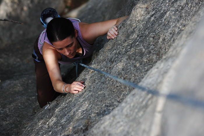 Beth Marek top rope climbing Hollywood (5.7), taken from the anchors of the route.  It was Beth's third time outside, and another long day of rock climbing at Seismic Wall on Austin's Barton Creek Greenbelt, Monday, May 25, 2009.

Filename: SRM_20090525_10391834.JPG
Aperture: f/4.0
Shutter Speed: 1/800
Body: Canon EOS-1D Mark II
Lens: Canon EF 80-200mm f/2.8 L