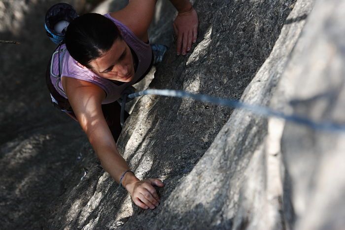 Beth Marek top rope climbing Hollywood (5.7), taken from the anchors of the route.  It was Beth's third time outside, and another long day of rock climbing at Seismic Wall on Austin's Barton Creek Greenbelt, Monday, May 25, 2009.

Filename: SRM_20090525_10393144.JPG
Aperture: f/5.6
Shutter Speed: 1/640
Body: Canon EOS-1D Mark II
Lens: Canon EF 80-200mm f/2.8 L