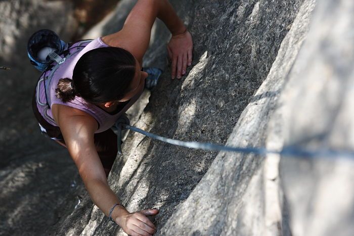 Beth Marek top rope climbing Hollywood (5.7), taken from the anchors of the route.  It was Beth's third time outside, and another long day of rock climbing at Seismic Wall on Austin's Barton Creek Greenbelt, Monday, May 25, 2009.

Filename: SRM_20090525_10393247.JPG
Aperture: f/5.6
Shutter Speed: 1/500
Body: Canon EOS-1D Mark II
Lens: Canon EF 80-200mm f/2.8 L