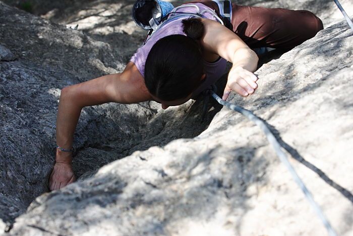 Beth Marek top rope climbing Hollywood (5.7), taken from the anchors of the route.  It was Beth's third time outside, and another long day of rock climbing at Seismic Wall on Austin's Barton Creek Greenbelt, Monday, May 25, 2009.

Filename: SRM_20090525_10413693.JPG
Aperture: f/5.6
Shutter Speed: 1/800
Body: Canon EOS-1D Mark II
Lens: Canon EF 80-200mm f/2.8 L