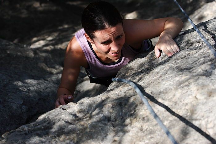 Beth Marek top rope climbing Hollywood (5.7), taken from the anchors of the route.  It was Beth's third time outside, and another long day of rock climbing at Seismic Wall on Austin's Barton Creek Greenbelt, Monday, May 25, 2009.

Filename: SRM_20090525_10414195.JPG
Aperture: f/5.6
Shutter Speed: 1/1600
Body: Canon EOS-1D Mark II
Lens: Canon EF 80-200mm f/2.8 L