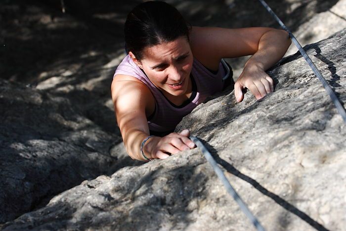 Beth Marek top rope climbing Hollywood (5.7), taken from the anchors of the route.  It was Beth's third time outside, and another long day of rock climbing at Seismic Wall on Austin's Barton Creek Greenbelt, Monday, May 25, 2009.

Filename: SRM_20090525_10414297.JPG
Aperture: f/5.6
Shutter Speed: 1/1600
Body: Canon EOS-1D Mark II
Lens: Canon EF 80-200mm f/2.8 L