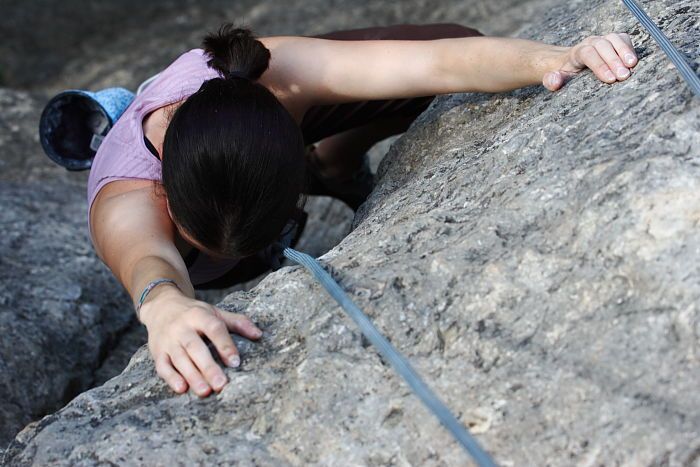 Beth Marek top rope climbing Hollywood (5.7), taken from the anchors of the route.  It was Beth's third time outside, and another long day of rock climbing at Seismic Wall on Austin's Barton Creek Greenbelt, Monday, May 25, 2009.

Filename: SRM_20090525_10423413.JPG
Aperture: f/5.6
Shutter Speed: 1/500
Body: Canon EOS-1D Mark II
Lens: Canon EF 80-200mm f/2.8 L