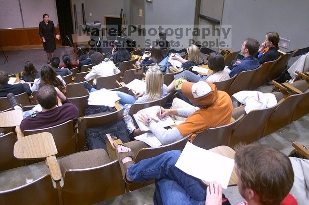 Jill Collum practicing her informative speech on massive hurricane prevention, using a tropical-storm generator.  The University of Texas' Speech Team will compete in the American Forensic Association’s National Individual Events Tournament (AFA NIET) in Gainesville, Florida, March 30 through April 4.

Filename: SRM_20060325_125958_8.jpg
Aperture: f/3.5
Shutter Speed: 1/20
Body: Canon EOS DIGITAL REBEL
Lens: Canon EF-S 18-55mm f/3.5-5.6