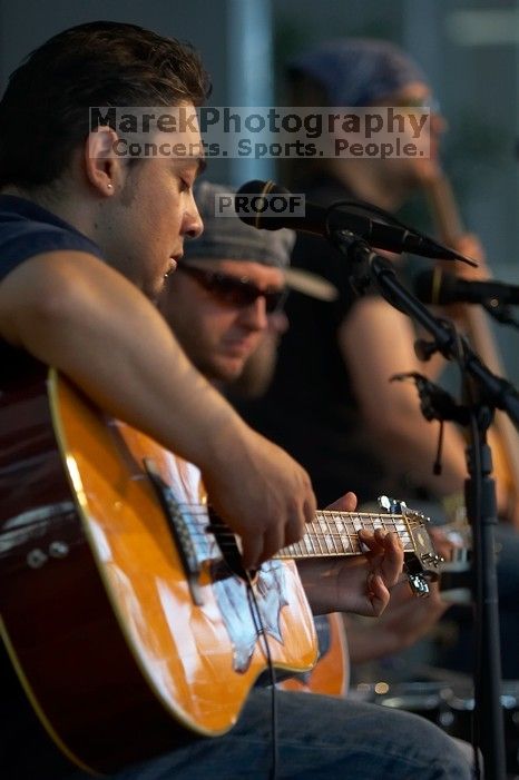 The Gene Pool, performing at the Austin airport.  Geno Stroia II on vocals/guitar, Jorge Castillo on vocals/guitar, Travis Woodard on drums and Steven Ray Will on vocals/bass guitar.

Filename: SRM_20060518_155650_2.jpg
Aperture: f/2.8
Shutter Speed: 1/250
Body: Canon EOS 20D
Lens: Canon EF 80-200mm f/2.8 L