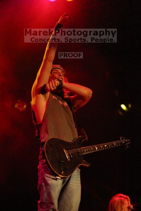 Puddle of Mudd performs on the first day of Music Midtown, 2004.

Filename: IMG_6071.jpg
Aperture: f/2.8
Shutter Speed: 1/160
Body: Canon EOS DIGITAL REBEL
Lens: Canon EF 80-200mm f/2.8 L