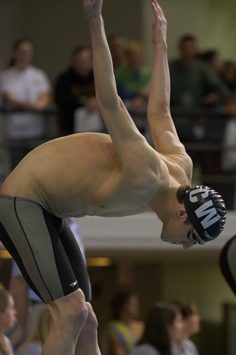 Michael Phelps of the University of Michigan Swim Team placed 1st in the last heat of the 200 IM Finals with a record time of 1:41.30, beating the old record of 1:41.71 at the Speedo American Short Course Championships.

Filename: SRM_20060304_192150_0.jpg
Aperture: f/3.5
Shutter Speed: 1/800
Body: Canon EOS 20D
Lens: Canon EF 80-200mm f/2.8 L