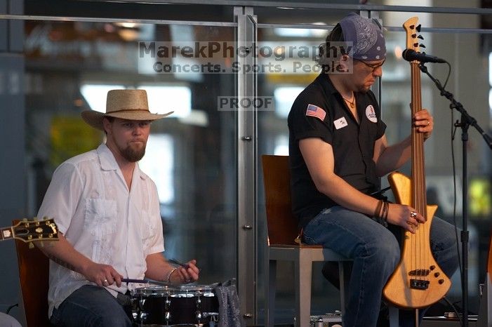 The Gene Pool, performing at the Austin airport.  Geno Stroia II on vocals/guitar, Jorge Castillo on vocals/guitar, Travis Woodard on drums and Steven Ray Will on vocals/bass guitar.

Filename: SRM_20060518_160204_9.jpg
Aperture: f/2.8
Shutter Speed: 1/250
Body: Canon EOS 20D
Lens: Canon EF 80-200mm f/2.8 L