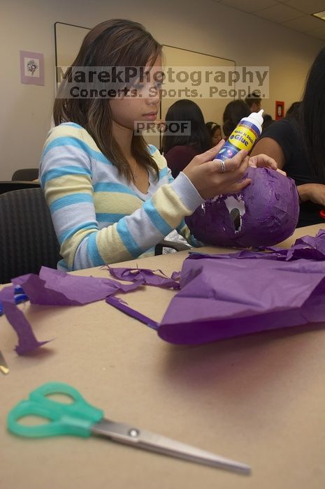 Mae Cortes decorates her mask at a domestic violence expressive arts workshop for survivors and friends of survivors of domestic and relationship violence.

Filename: SRM_20061023_1736104.jpg
Aperture: f/5.6
Shutter Speed: 1/100
Body: Canon EOS 20D
Lens: Canon EF-S 18-55mm f/3.5-5.6