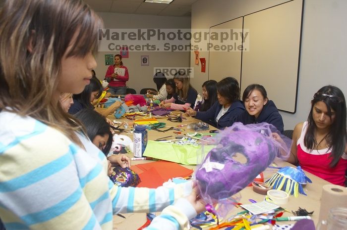 Mae Cortes decorates her mask at a domestic violence expressive arts workshop for survivors and friends of survivors of domestic and relationship violence.

Filename: SRM_20061023_1803488.jpg
Aperture: f/5.6
Shutter Speed: 1/100
Body: Canon EOS 20D
Lens: Canon EF-S 18-55mm f/3.5-5.6