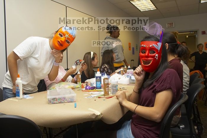 Hannah Yee, left, and Emily Ng show off their masks at a domestic violence expressive arts workshop for survivors and friends of survivors of domestic and relationship violence.

Filename: SRM_20061023_1806106.jpg
Aperture: f/5.6
Shutter Speed: 1/100
Body: Canon EOS 20D
Lens: Canon EF-S 18-55mm f/3.5-5.6