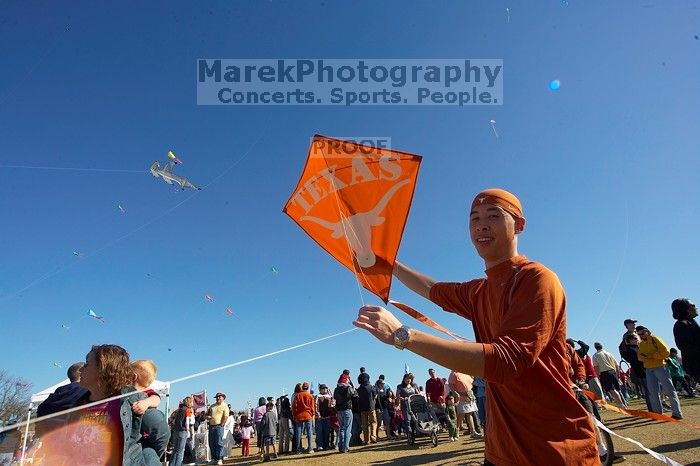 Chris Lam attempts to fly his UT kite at the 79th annual Zilker Park Kite Festival, Sunday, March 4, 2007.

Filename: SRM_20070304_1531446.jpg
Aperture: f/11.0
Shutter Speed: 1/250
Body: Canon EOS-1D Mark II
Lens: Sigma 15-30mm f/3.5-4.5 EX Aspherical DG DF